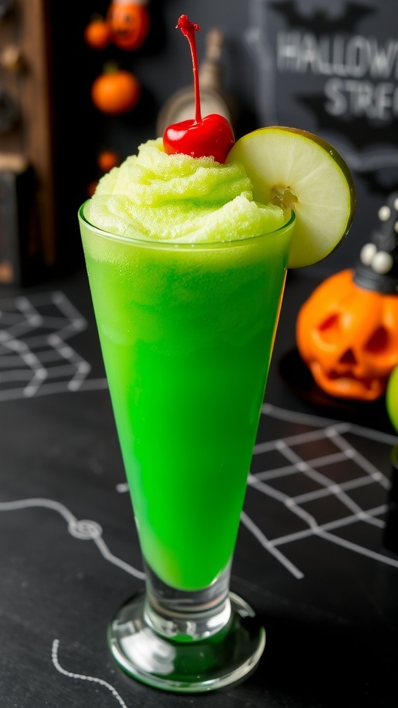 A refreshing green apple slush in a glass, garnished with apple slices and cherry, set against a Halloween backdrop.